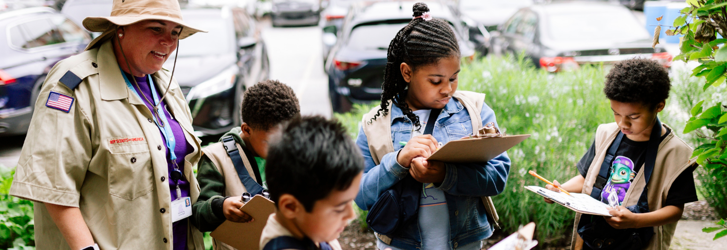 Students in Discovery Club exploring the front garden at Baltimore Lab.